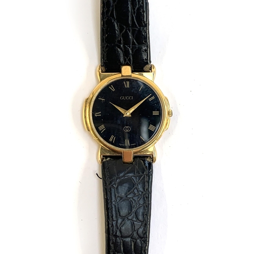53 - A Gucci ladies watch model 3400 FM, gold tone with black dial and leather strap