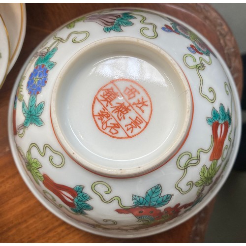 122 - A Chinese famille verte celadon plate, decorated with insects, precious objects and a phoenix, marks... 