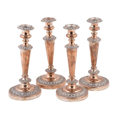 85 - A set of four old Sheffield plate circular candlesticks, circa 1830, 28cm (11in) high