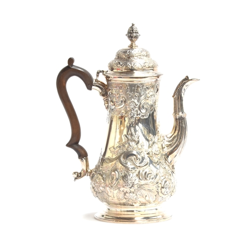 62 - A late Victorian silver coffee pot by F B Thomas & Co, London 1897, heavily chased with foliage and ... 