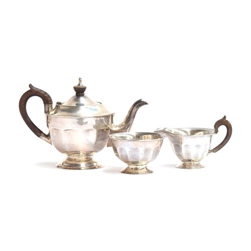 59 - A three piece teaset by Viners, Sheffield 1960, of circular and dodecagonal form, on a spreading cir... 