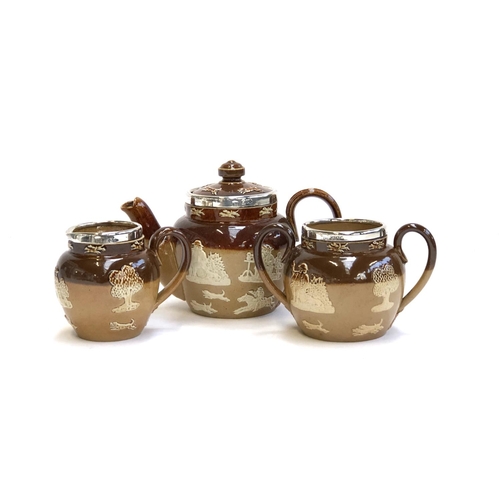 120 - A miniature Royal Doulton Lambeth Stoneware tea set, comprising teapot, 10.5cmH, milk jug, and sugar... 