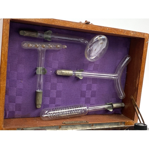 250 - A Violet Ray Vitalator no. 3922, bakelite with four glass attachments, in a wooden case, 26cmW