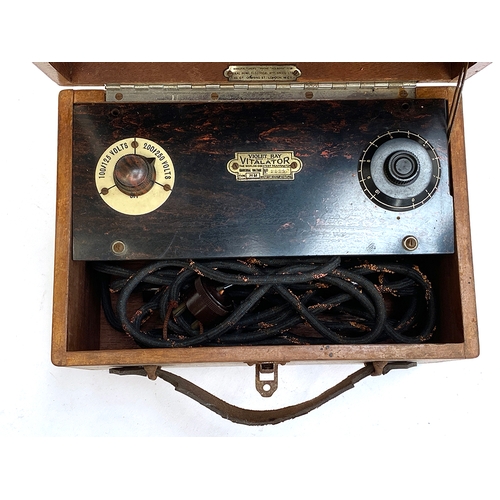 250 - A Violet Ray Vitalator no. 3922, bakelite with four glass attachments, in a wooden case, 26cmW