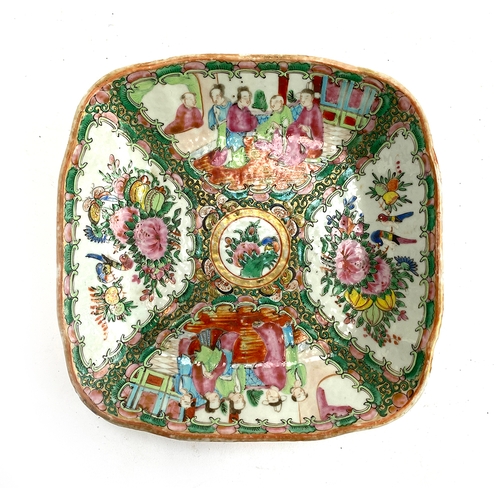 133 - A Chinese famille rose dish of square form, four panels depicting court scenes and flora surrounding... 