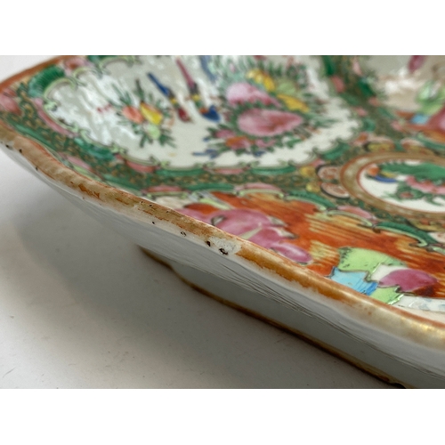 133 - A Chinese famille rose dish of square form, four panels depicting court scenes and flora surrounding... 