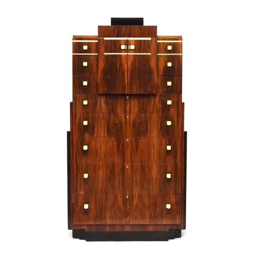 722 - A French Art Deco maccasar ebony pedestal chest, stepped top, over a pair of cupboard doors and an a... 