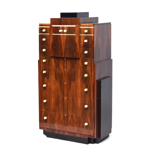 722 - A French Art Deco maccasar ebony pedestal chest, stepped top, over a pair of cupboard doors and an a... 