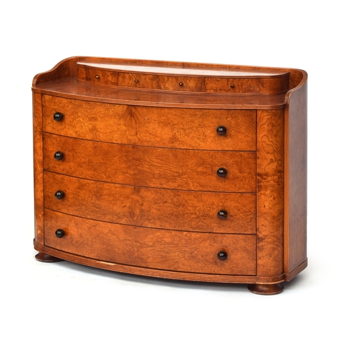 726 - An Austrian birch veneer bowfront commode, c.1935, the superstructure with four small drawers over f... 