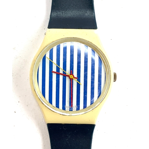 105 - A Swatch watch with blue and white striped face, together with an Old England watch