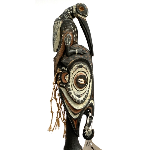 272 - A Nepalese kukri, together with a Papua New Guinea mameri flute carved as a bird on a man's head, a ... 