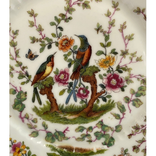 167 - A set of nine early 20th century plates, decorated with birds in trees, heightened in gilt, Chelsea ... 