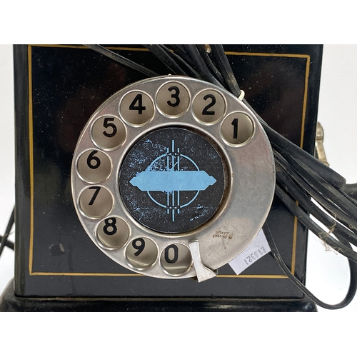 331 - Three vintage telephones: A 1950s ivory coloured French rotary dial, a candlestick telephone, and a ... 