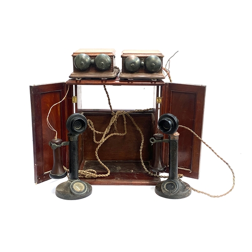 335 - Two 1920s bakelite candlestick telephones, model no. 150, PL 124 No.22, each with bell boxes, in pur... 