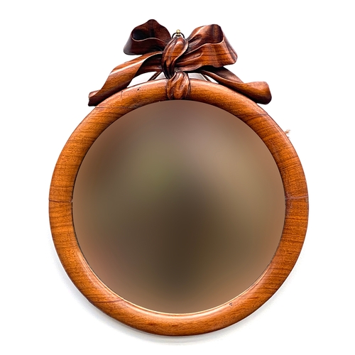 A Victorian mahogany framed circular mirror, with carved ribbon cresting, 38x41cm
