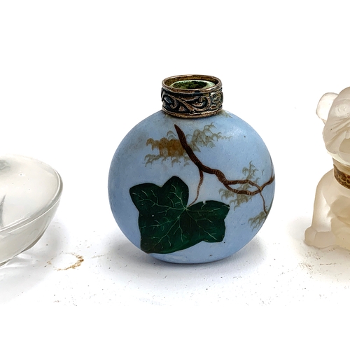 195 - A frosted glass perfume bottle in the form of a bulldog; together with others including one hand pai... 