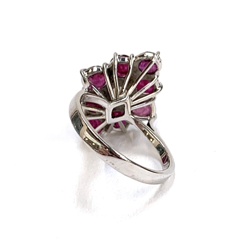 37 - A 9ct white gold ring set with a navette form cluster of rubies and a central opal, size J, 3.2g