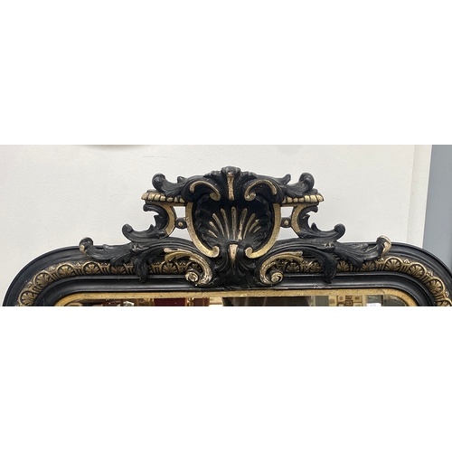 851 - A large guilt and ebonised over mantle mirror, with shell cresting, 84x150cm