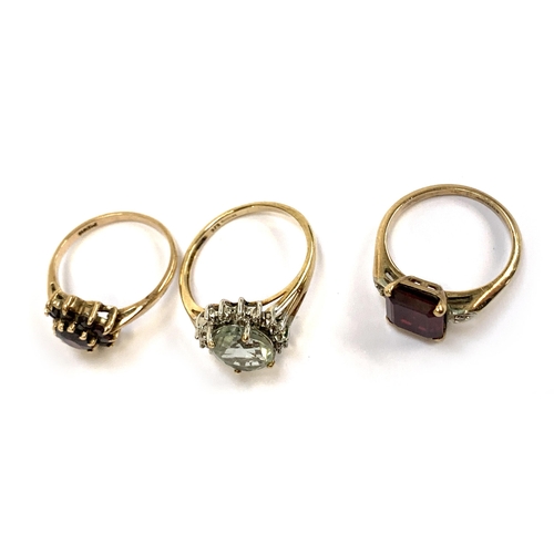 15 - Three 9ct gold rings: one set with garnets size M, one synthetic ruby size L, the other green quartz... 