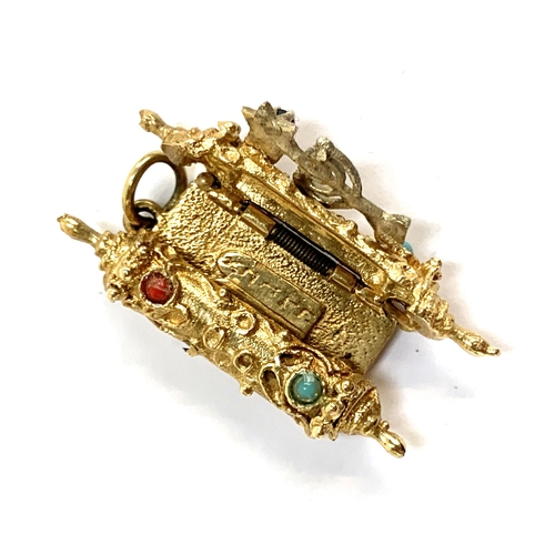 9 - A gold Torah charm with minora detail set with a sapphire, tests as 14ct, 8g