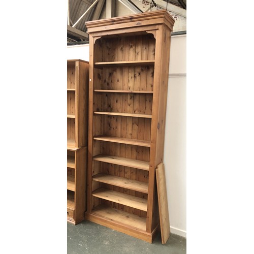 1174 - A very tall pine bookcase with seven adjustable shelves, 105x28x260cmH