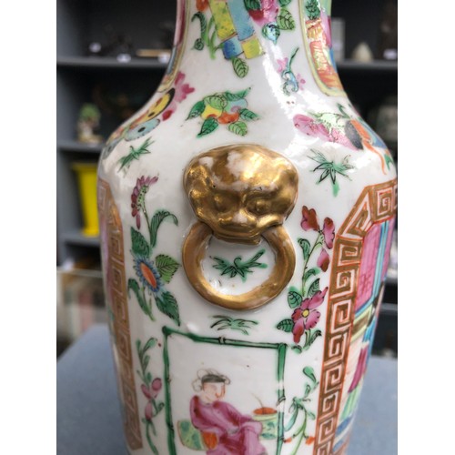 221 - A late 19th century Chinese famille rose vase of baluster form with applied lion mask handles, depic... 