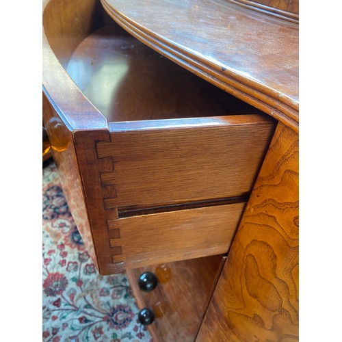 726 - An Austrian birch veneer bowfront commode, c.1935, the superstructure with four small drawers over f... 