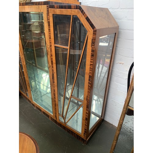 719A - A figured walnut and Macassar ebony Art Deco style display cabinet, the stepped top with similar sma... 