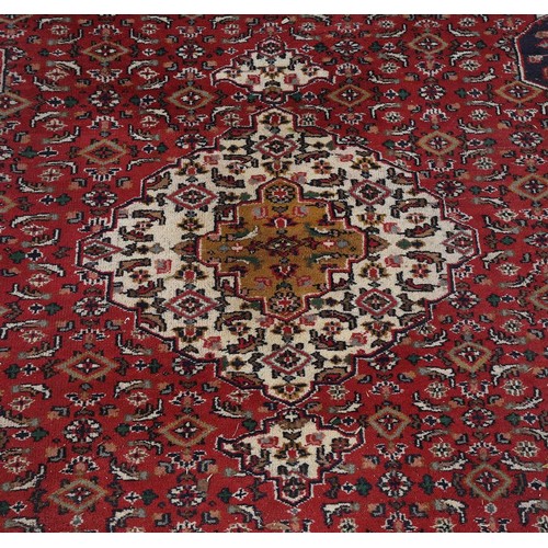 651 - A North West Persian carpet, with red ground, approx. 350x260cm