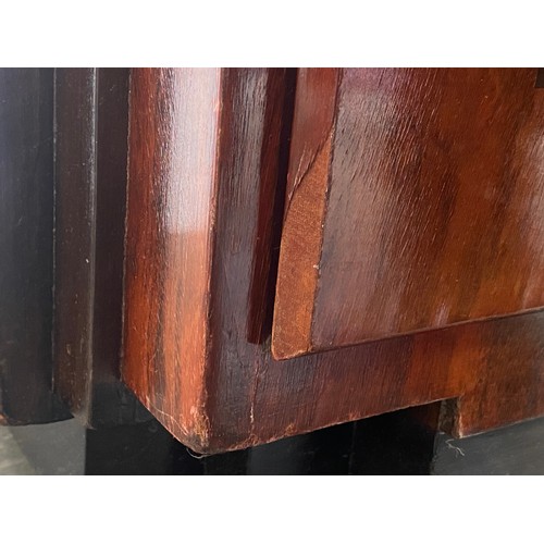 703 - A French Art Deco maccasar ebony pedestal chest, stepped top, over a pair of cupboard doors and an a... 