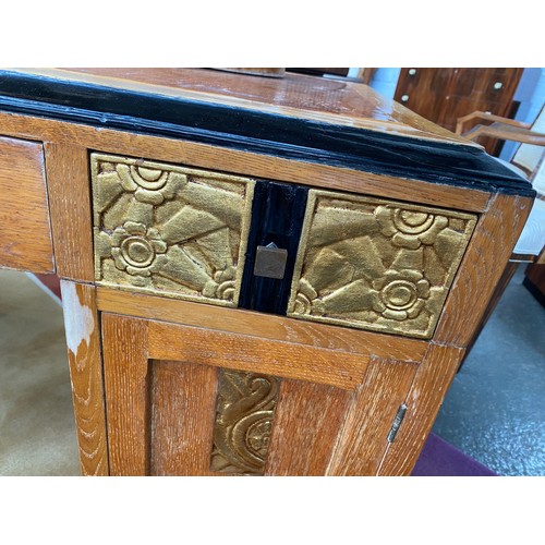 705 - A French Art Deco pedestal desk, parcel gilt and ebonised, with carved foliate and scallop panels, t... 