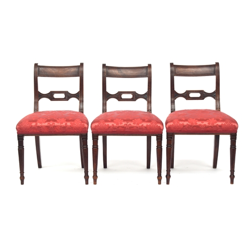 813 - A set of six William IV mahogany dining chairs, the ebony inlaid top rail on reeded scroll supports,... 