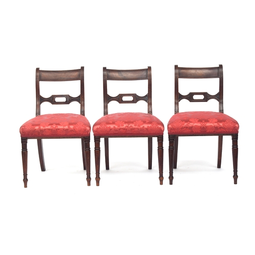 813 - A set of six William IV mahogany dining chairs, the ebony inlaid top rail on reeded scroll supports,... 