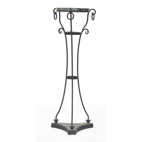 858 - A wrought iron and serpentine marble gueridon pot stand, circular top, the three scrolling supports ... 