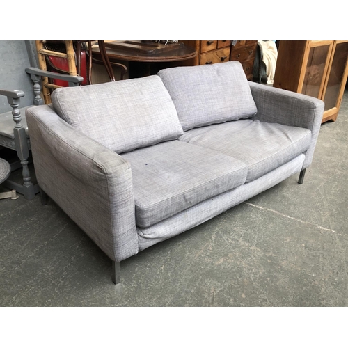 955 - A contemporary grey two seater sofa on chromed steel frame, 168cm wide 90cm deep