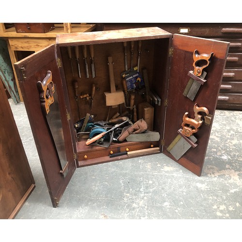 956 - A teak carpenters cabinet, fitted interior, hung with various tools, to include Marples chisels, 66x... 