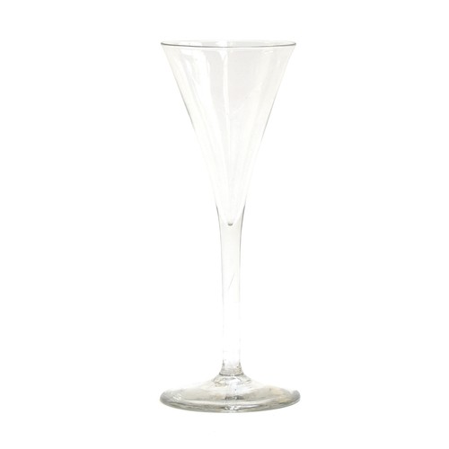 241 - A plain stemmed toasting glass, mid-18th century, of drawn trumpet form and conical foot, 19.5cm hig... 