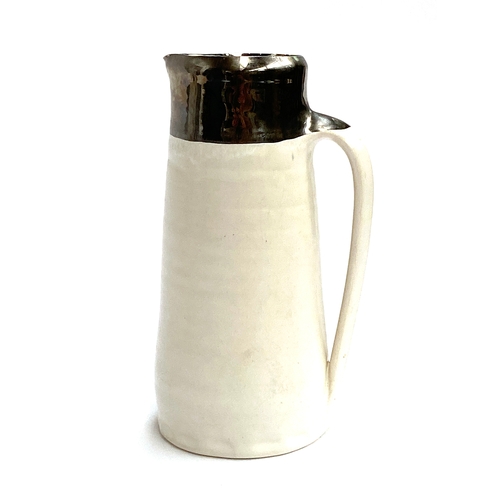 224 - Nicola Tassie (b.1960), a studio pottery jug with silvered rim, marked to base, 17cmH