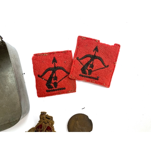 320 - A tin containing military regimental badges, 'Malborough College Corps', Royal Navy artillery badge ... 