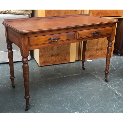 815 - A Maple & Co Ltd London & Paris console table of two drawers, on turned legs and casters, 115x52x77c... 