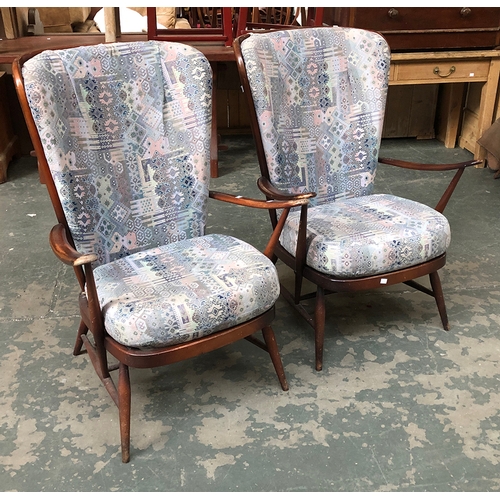 889 - An Ercol three piece suite comprising two stickback armchairs and a sofa with solid elm back, 208cmW