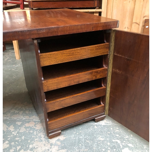 901 - A 20th century Iroko pedestal desk, each pedestal with cupboard door opening to four slides, the out... 