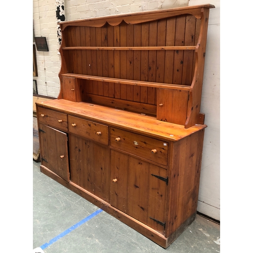 943 - A large 20th century pine kitchen dresser, the base with three drawers over doors, 198x50x187cmH