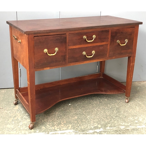 725 - A 20th century mahogany buffet, four drawers with brass handles above a shaped undershelf, on taperi... 