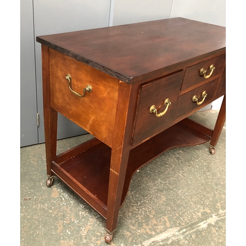 725 - A 20th century mahogany buffet, four drawers with brass handles above a shaped undershelf, on taperi... 