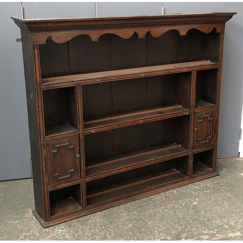 738 - An 18th century and later century oak kitchen dresser, the top with four shelves with pigeon holes a... 