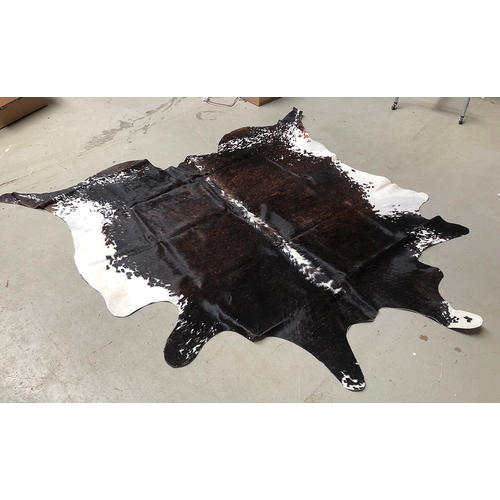 917 - A cowhide rug, approx. 230x217cm