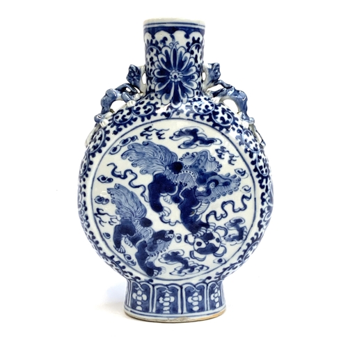 239 - A Chinese blue and white porcelain moon flask, decorated with foo lions amongst ruyi clouds within a... 