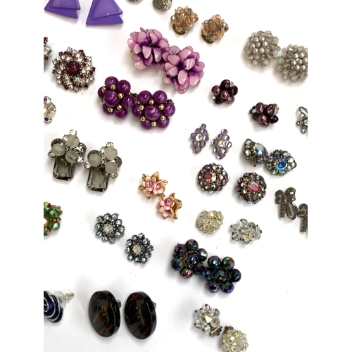 49 - A quantity of costume clip on earrings, some purple and green tone, aurora borealis crystal etc