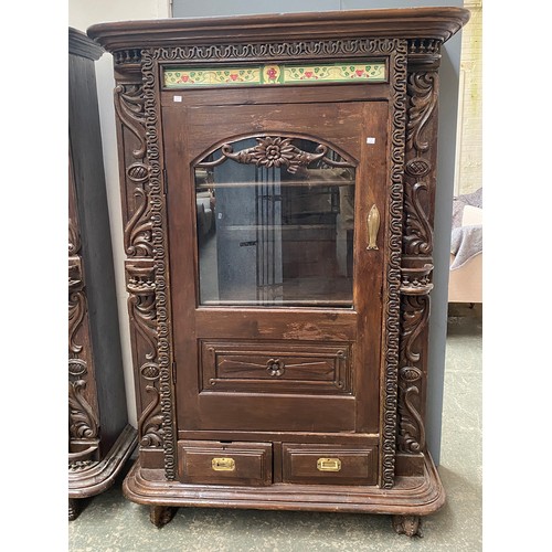 965 - An Indo-Portuguese carved cabinet with Art Novueau tiled frieze over a glazed cupboard door, two doo... 